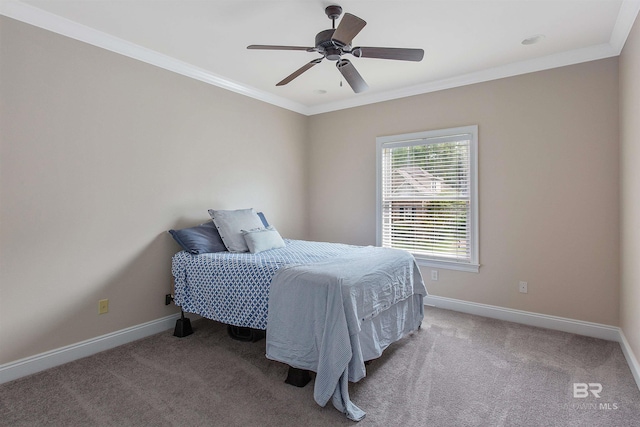 carpeted bedroom featuring ceiling fan and crown molding