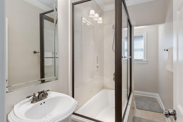 bathroom with tile flooring, sink, and ornamental molding