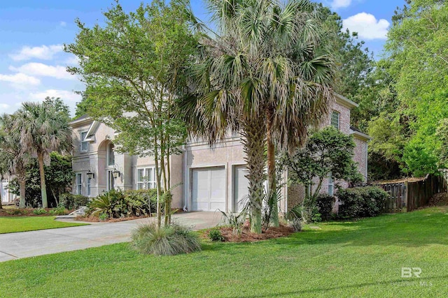 view of front of property with a front lawn and a garage