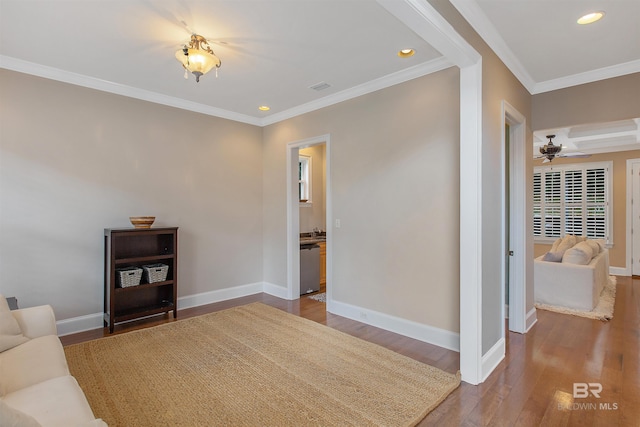 living room with ceiling fan, ornamental molding, and dark wood-type flooring