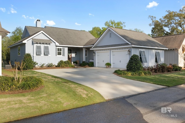 single story home with an attached garage, a chimney, concrete driveway, a front lawn, and board and batten siding
