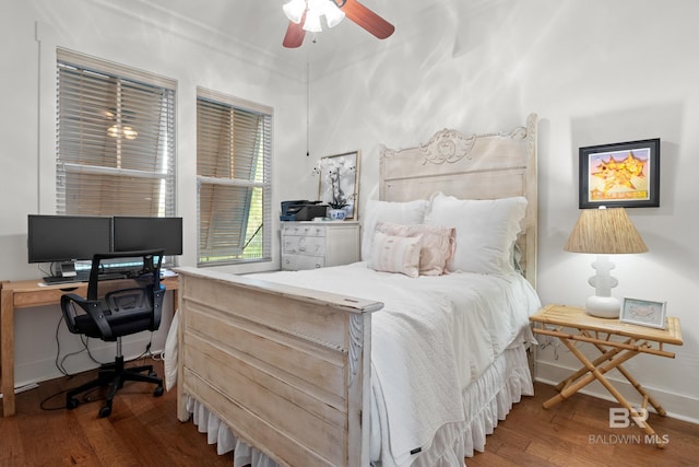bedroom with baseboards and wood finished floors