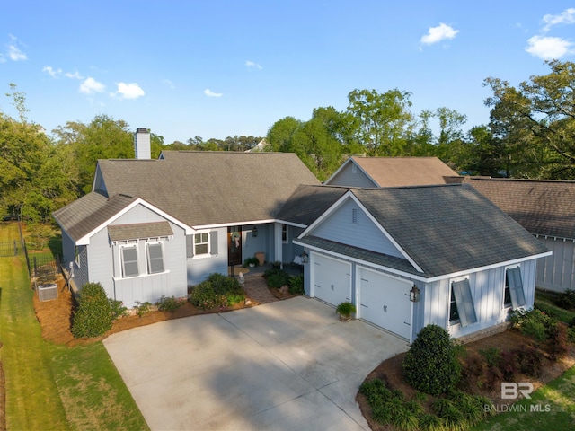 single story home featuring driveway, roof with shingles, a chimney, board and batten siding, and a garage