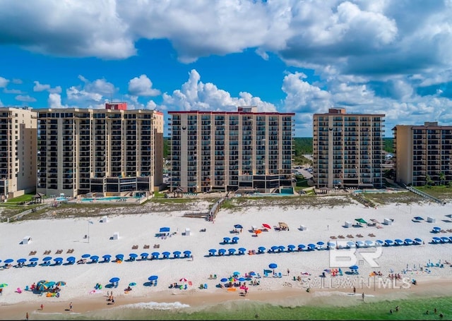 view of property featuring a water view and a beach view