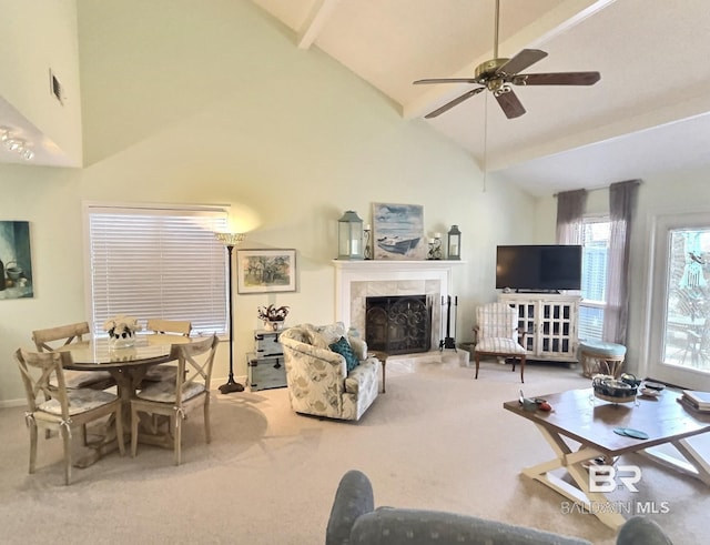 living room featuring carpet floors, a tile fireplace, beamed ceiling, and ceiling fan