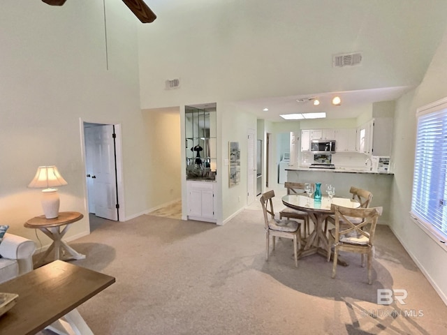 dining room featuring visible vents, light carpet, and baseboards