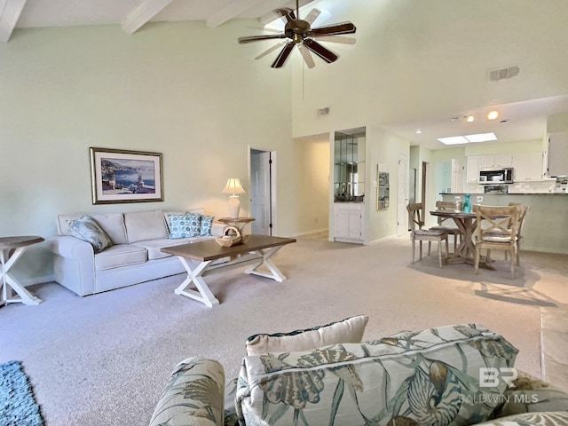 living area with high vaulted ceiling, beam ceiling, visible vents, and light carpet