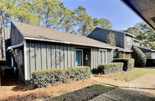 view of front of house with board and batten siding and roof with shingles