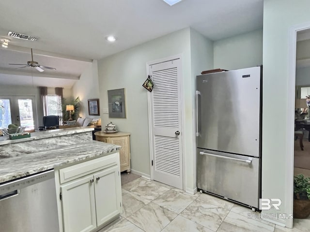 kitchen with marble finish floor, stainless steel appliances, visible vents, open floor plan, and white cabinetry