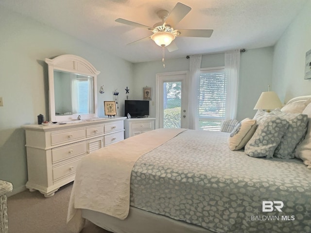 bedroom with access to exterior, carpet, a textured ceiling, and a ceiling fan