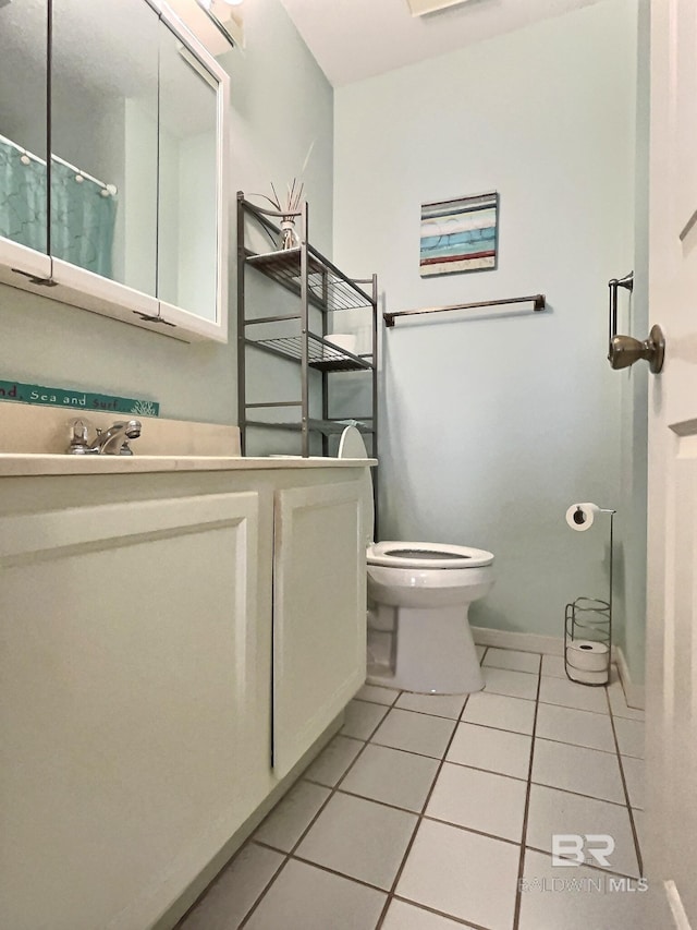 full bath with baseboards, vanity, toilet, and tile patterned floors