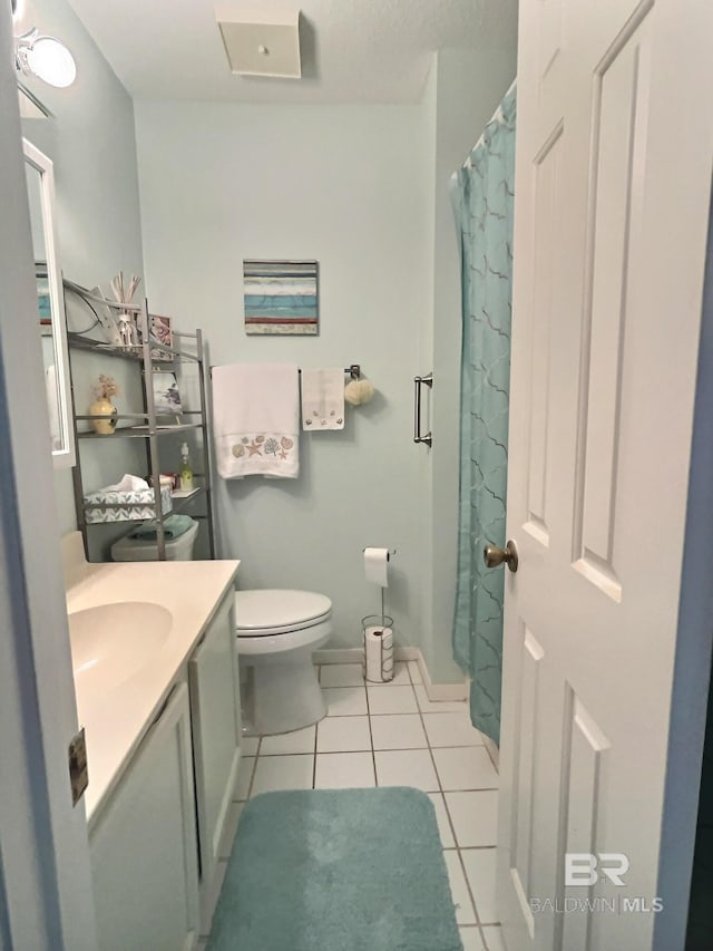 full bath with baseboards, vanity, toilet, and tile patterned floors