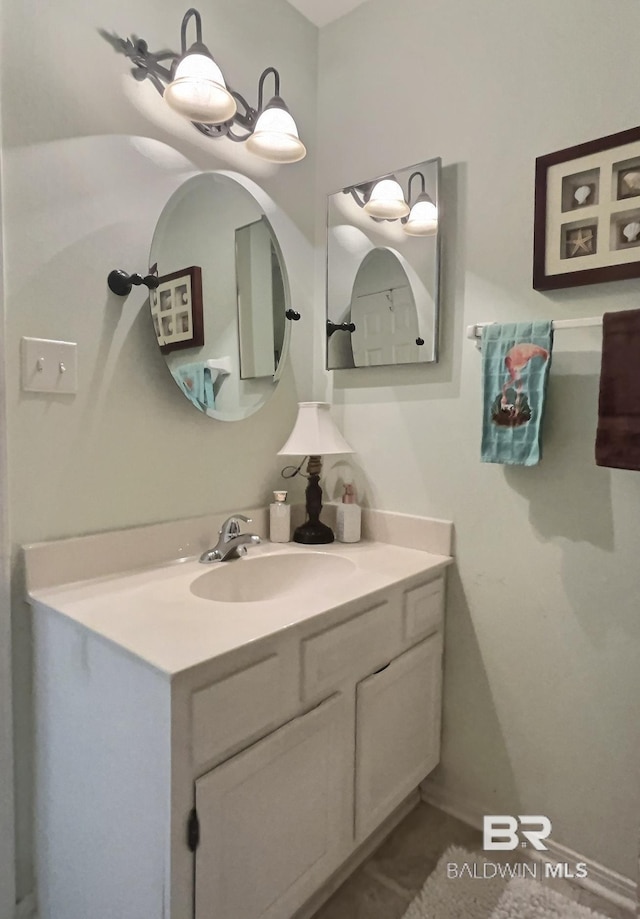 bathroom with vanity and baseboards