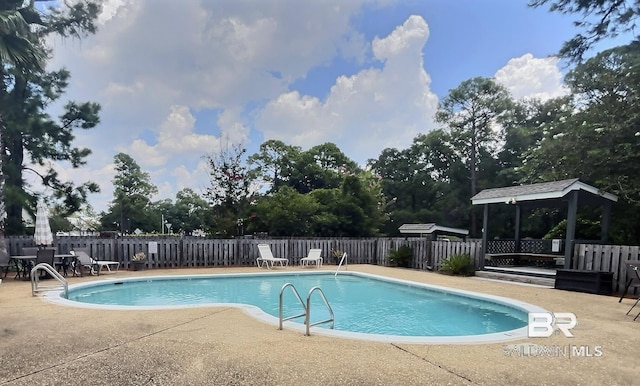 pool featuring a patio, a gazebo, and fence