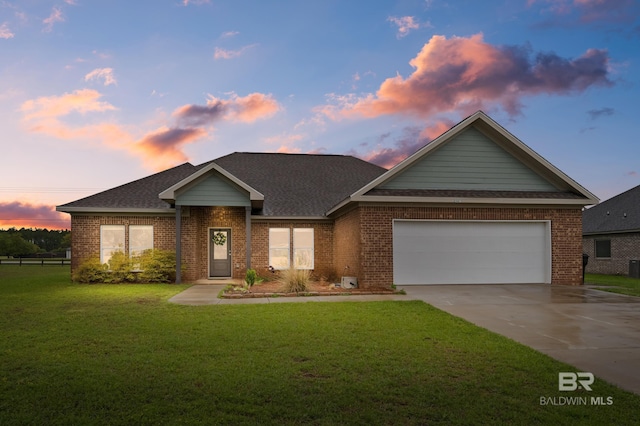 ranch-style home featuring a lawn, brick siding, concrete driveway, and roof with shingles