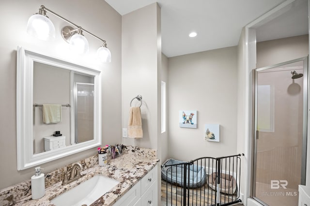 full bathroom featuring a stall shower, recessed lighting, and vanity