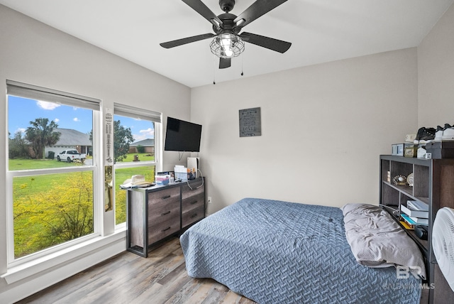 bedroom with wood finished floors and a ceiling fan