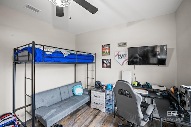 bedroom featuring wood finished floors, ceiling fan, and visible vents