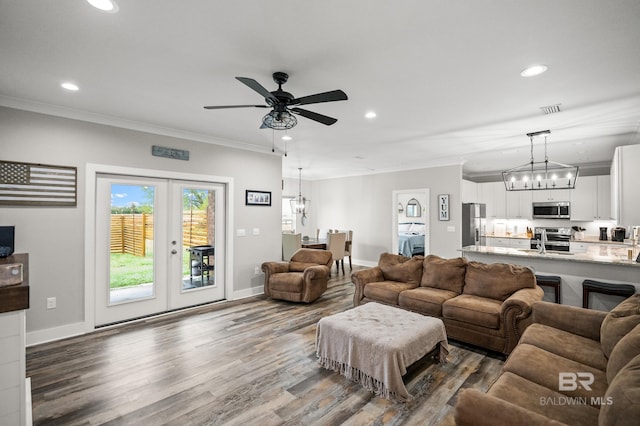 living room featuring ornamental molding, visible vents, and recessed lighting