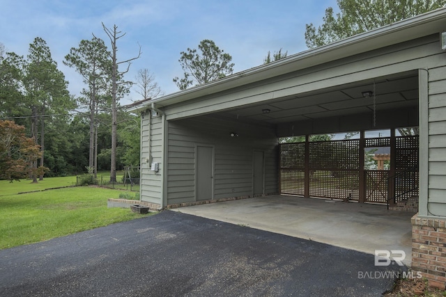 view of parking / parking lot with a carport and a lawn