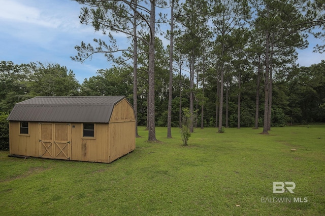 view of outbuilding with a yard