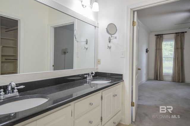 bathroom featuring vanity and ornamental molding