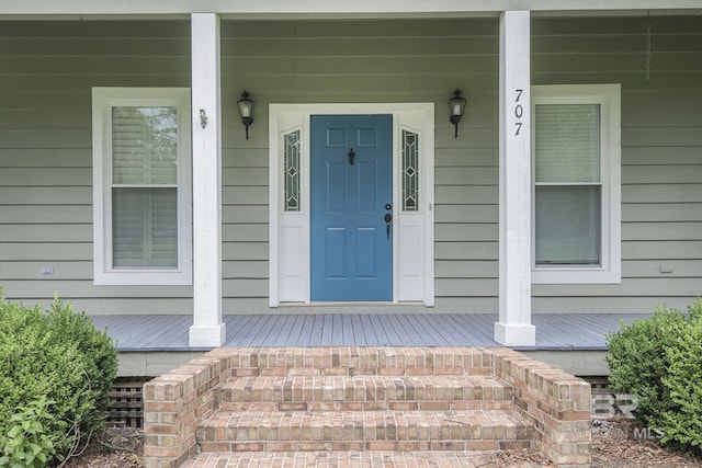 view of exterior entry with covered porch