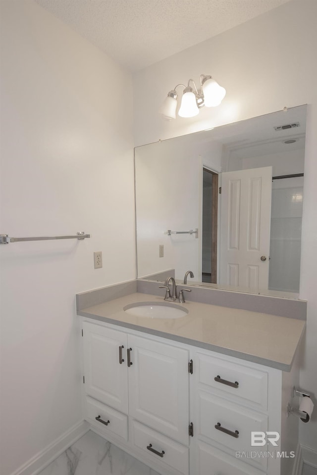 bathroom featuring vanity and a textured ceiling