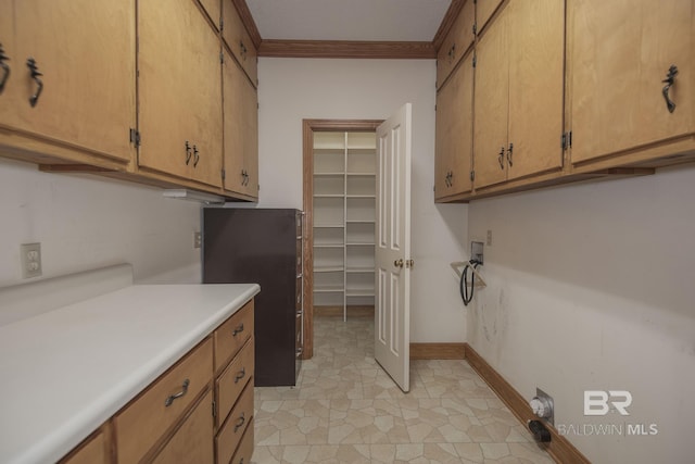 washroom with ornamental molding and cabinets