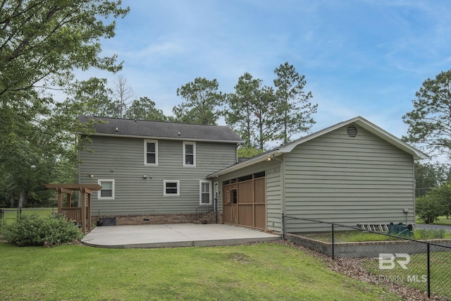 rear view of property with a yard and a patio area