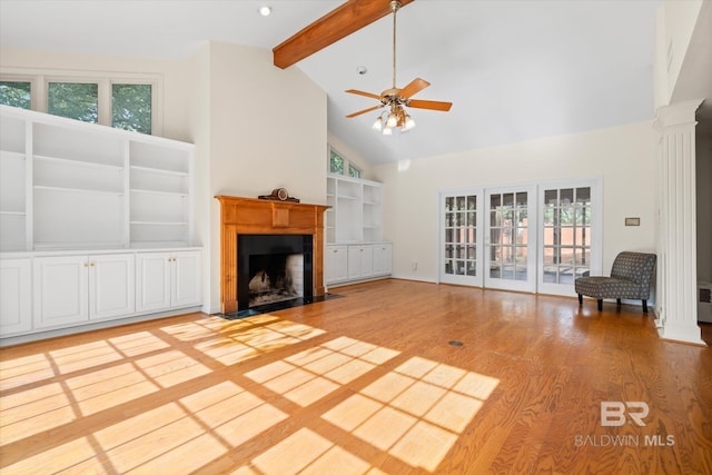 unfurnished living room featuring hardwood / wood-style floors, high vaulted ceiling, and a wealth of natural light