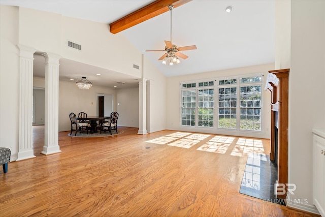 living room with ornate columns, lofted ceiling with beams, ceiling fan with notable chandelier, and light wood-type flooring