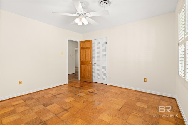 unfurnished bedroom with ceiling fan and light parquet floors