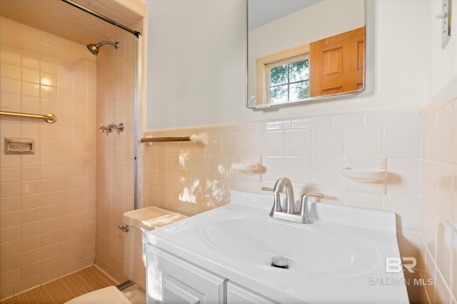 bathroom featuring vanity, a tile shower, and tile walls