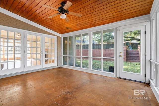 unfurnished sunroom featuring ceiling fan, lofted ceiling, wood ceiling, and french doors