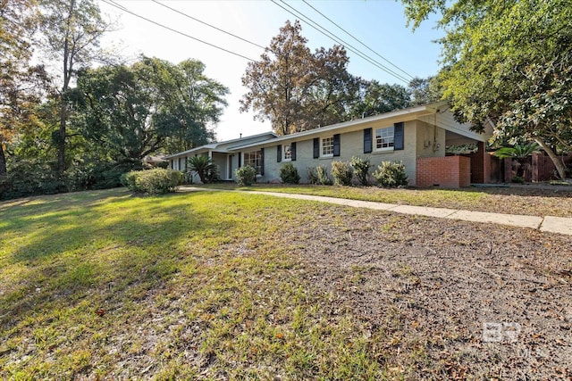 ranch-style home with a front lawn