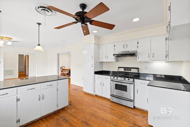 kitchen with ceiling fan, stainless steel gas range, crown molding, light hardwood / wood-style floors, and white cabinets