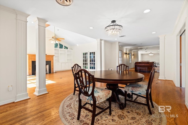 dining space with ornamental molding, ceiling fan with notable chandelier, and light wood-type flooring