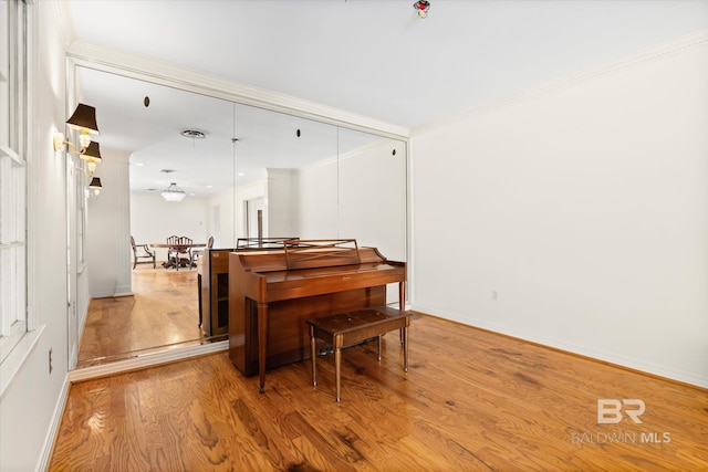 misc room with crown molding and light hardwood / wood-style flooring