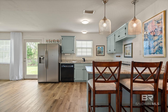 211 Fels Ave, Fairhope, AL 36532 - kitchen with stainless steel refrigerator with ice dispenser, a sink, light wood-style flooring, dishwasher, and hanging light fixtures