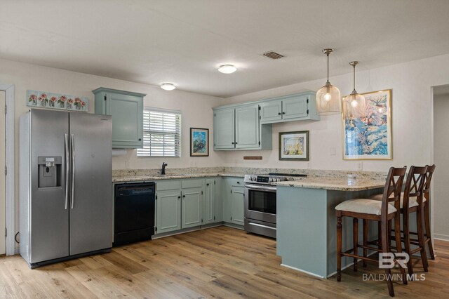 211 Fels Ave, Fairhope, AL 36532 - kitchen featuring a sink, appliances with stainless steel finishes, light wood-type flooring, and a peninsula