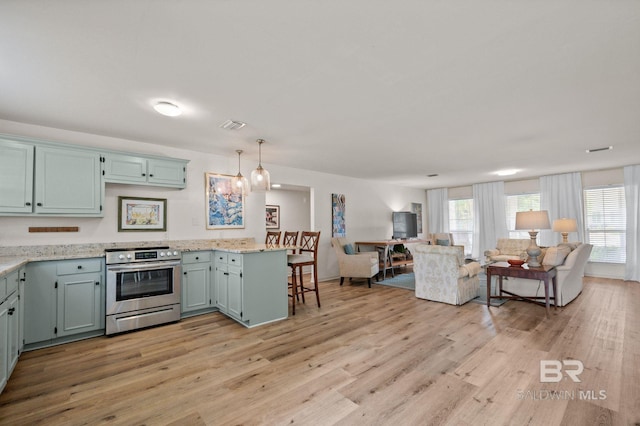 211 Fels Ave, Fairhope, AL 36532 - kitchen featuring open floor plan, light wood-style flooring, a healthy amount of sunlight, and stainless steel electric range oven