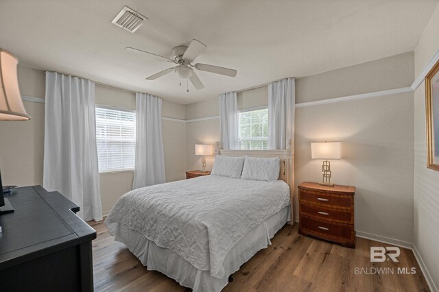 211 Fels Ave, Fairhope, AL 36532 - bedroom with baseboards, ceiling fan, wood finished floors, and visible vents