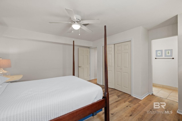 211 Fels Ave, Fairhope, AL 36532 - bedroom with baseboards, a ceiling fan, a closet, and light wood finished floors