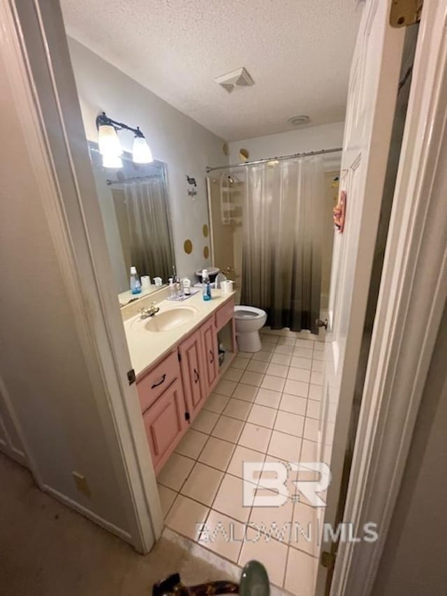 114 Dewitt Cir, Daphne, AL 36526 - bathroom with a textured ceiling, visible vents, toilet, tile patterned floors, and vanity