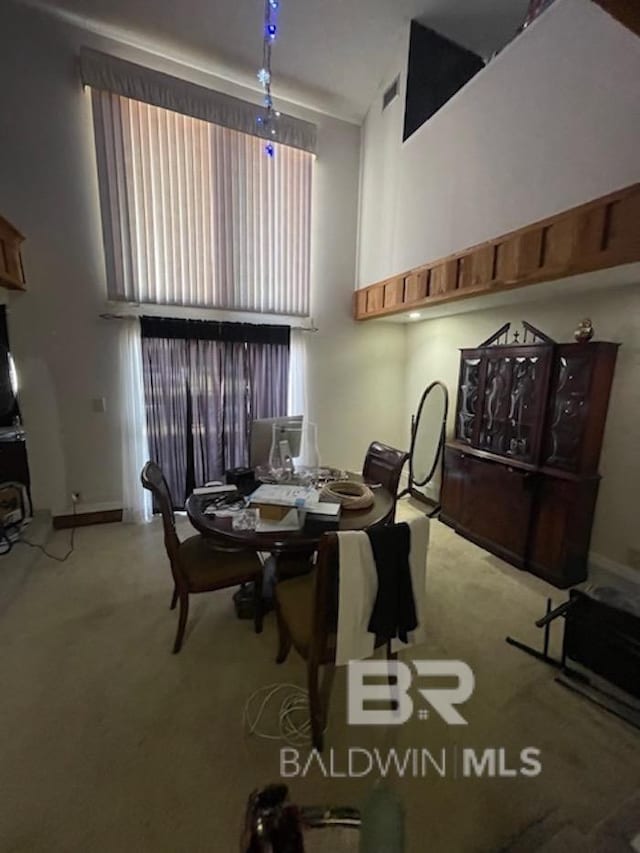 114 Dewitt Cir, Daphne, AL 36526 - dining area with a towering ceiling, baseboards, and carpet floors