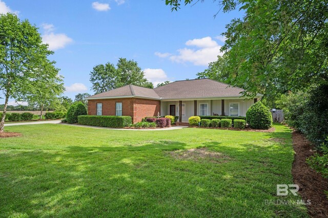 16520 Gaineswood Dr, Fairhope, AL 36532 - ranch-style home with a front yard, brick siding, and board and batten siding