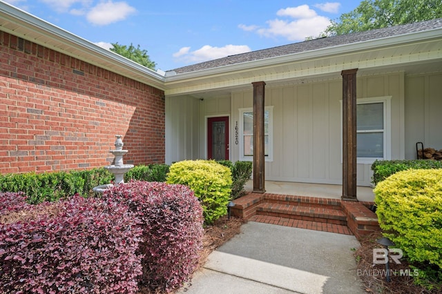 16520 Gaineswood Dr, Fairhope, AL 36532 - entrance to property featuring roof with shingles, brick siding, covered porch, and board and batten siding