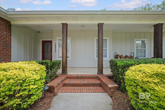 16520 Gaineswood Dr, Fairhope, AL 36532 - view of exterior entry with board and batten siding and a porch