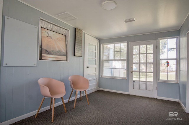 interior space featuring dark carpet, visible vents, and baseboards